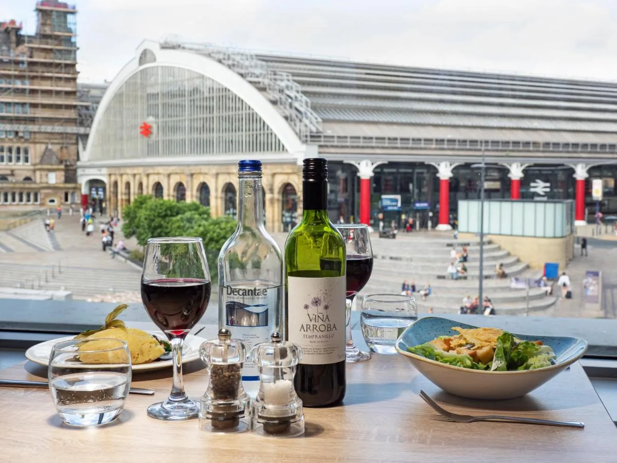 A table with two bottles of wine and a bowl of food at Holiday Inn Liverpool City Centre by IHG in Liverpool