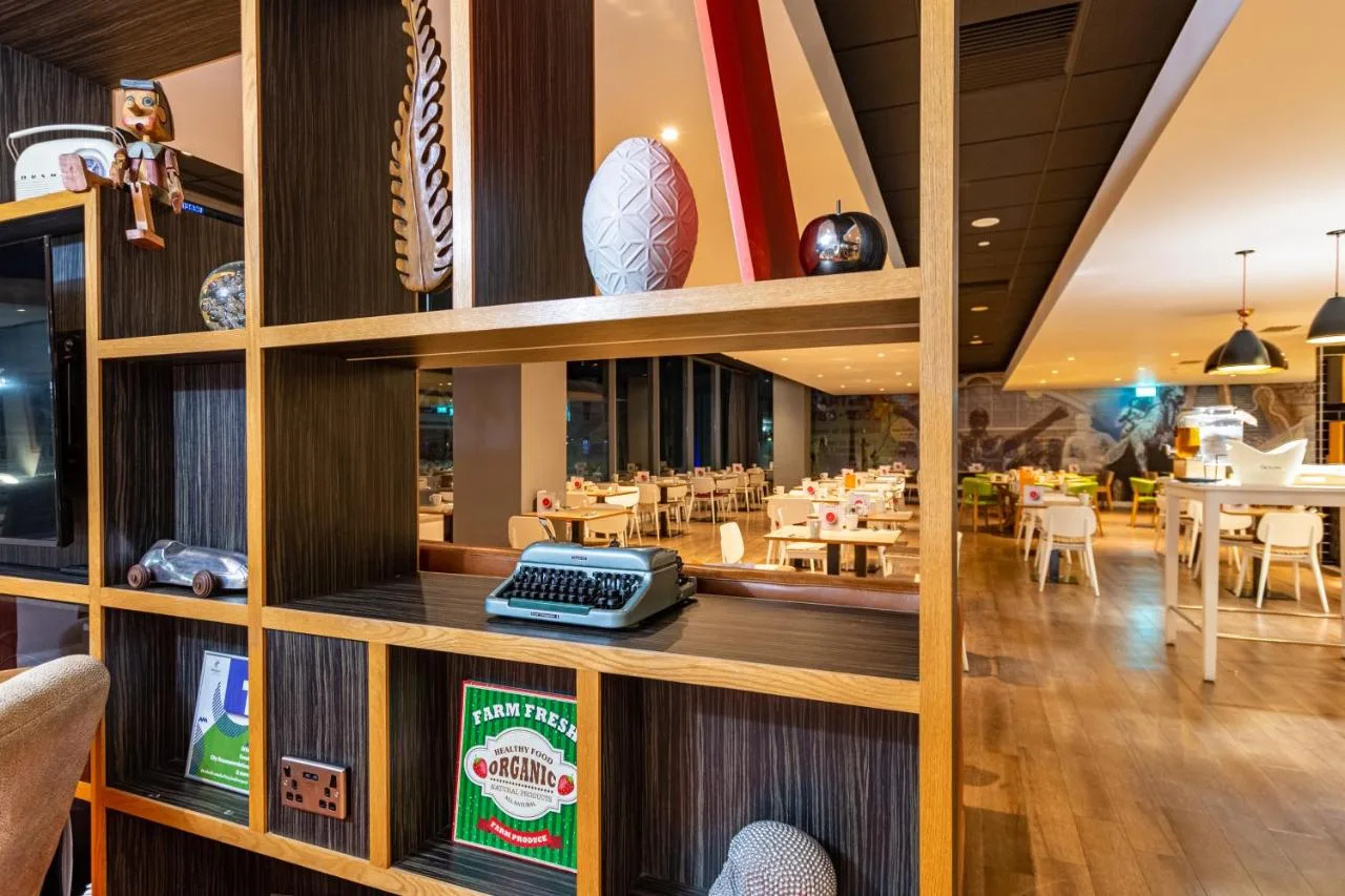 A restaurant with wooden walls and tables and chairs at Holiday Inn Liverpool City Centre by IHG in Liverpool